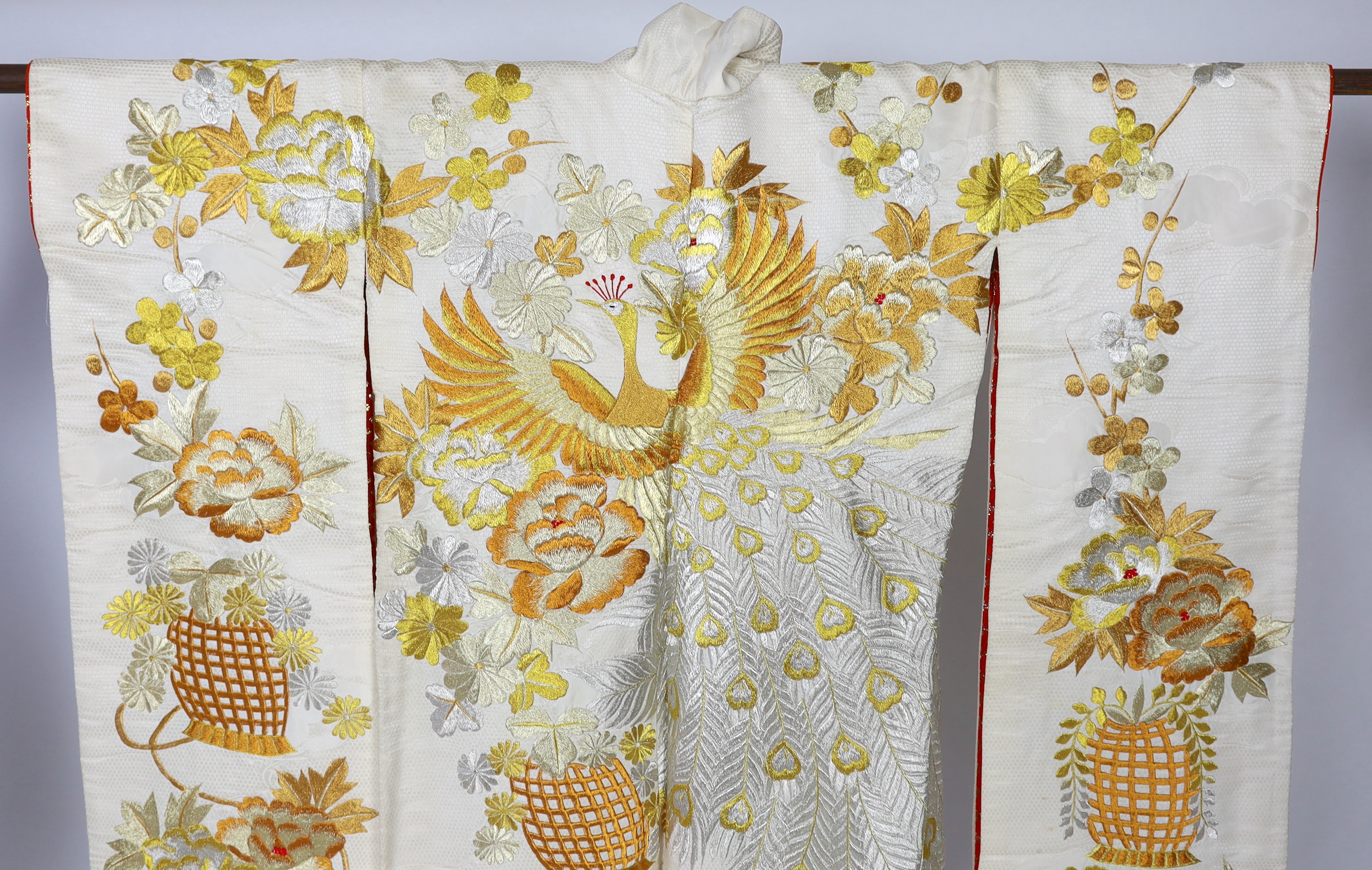 A 1960s-70s vintage Japanese embroidered wedding kimono, embroidered with pewter, bronze, silver and gold coloured metallic threads, into a large decorative design of peacocks with fanned tail feathers and trailing flowe